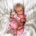 Detail of 18 inch Bettie reborn doll with blue eyes, blonde hair and Little Cutie outfit - Full Silicone Body Style