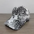 Close-up of distressed baseball cap with silver sequins and frayed edge details - Black