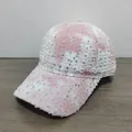 Detail of pink tie-dye baseball cap featuring silver sequins and distressed fabric texture - Pink