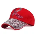 Detailed view of red cotton baseball cap with pink rhinestone ribbon and studded brim - Red