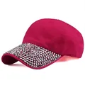 Detailed close-up of shiny rhinestones on the brim of a pink cotton baseball cap - Adjustable / Rose Red