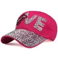 Macro detail of rhinestone LOVE lettering and sparkling crystals on pink baseball cap - Adjustable / Rose Red