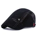 Détail d'une casquette plate noire avec emblème crâne en métal et broderie latérale - Réglable / Noir