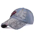 Detail view of denim baseball cap with LOVE rhinestone letters and silver cone studs - Adjustable / Light Washed Denim