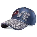 Detail of LOVE rhinestone patterns and worn-out effects on dark blue denim baseball cap - Adjustable / Denim Blue