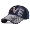 Detail of denim baseball cap with rhinestone LOVE lettering and silver cone studs - Adjustable / Dark Denim Blue