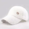 Detail of white sherpa fleece texture and round metal M logo on the winter baseball cap - Adjustable / White No Pom Pom