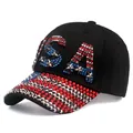 Detailed view of glittering USA rhinestone letters and silver star studs on a black cap - Adjustable / Black