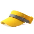 Detailed macro view of yellow sun visor featuring sparkling silver rhinestone band decor - Flat Rhinestone Style / Yellow