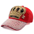 Detailed close-up of red baseball cap with golden crown sequins and pearl brim decorations - Adjustable / Red
