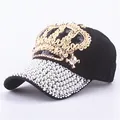 Detailed close-up of a black baseball cap with golden crown sequins and white pearls - Adjustable / Black
