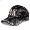 Detail of floral lace texture and sparkling rhinestone 'MAKE' lettering on a black baseball cap - Adjustable / Black