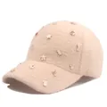 Detailed close-up of beige plush baseball cap with colorful star and flower ornaments - Adjustable / Khaki