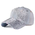 Close-up of sparkling diamond butterfly pattern on light blue denim baseball cap - Adjustable / Light Blue Denim