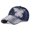 Detail of distressed navy denim baseball cap with rhinestone butterfly and silver studs - Adjustable / Deep Blue Denim