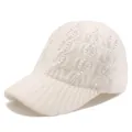 Detailed macro view of the knitted texture and colorful rhinestones on the cream winter cap - Adjustable / White