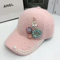 Detail of pink plush baseball cap with pearls, floral ornaments, and a deer brooch - Adjustable / Pink