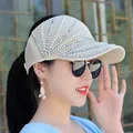 Close-up of cream knitted sun visor with elegant radial pearls and rhinestones - Adjustable / Beige