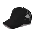 Detail view of a black trucker hat with breathable mesh panels and curved brim - Adjustable / Black