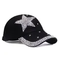 Close-up of black baseball cap with rhinestone star pattern and studded brim detail - Adjustable / Black
