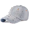 Detail of light blue denim baseball cap with silver metal star studs and frayed edges - Denim Light Blue
