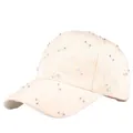 Close-up of cream baseball cap featuring 3D floral embroidery and sparkling rhinestones - Off White