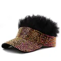 Close-up of sparkling golden rhinestones and black faux fur trim on a sun hat - Black Hair Red Rhinestones