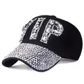 Detail of a black baseball cap featuring large VIP rhinestone letters and a studded brim - Clear Rhinestone Black