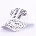 Detail of white baseball cap featuring VIP rhinestone letters and studded brim decoration - Clear Rhinestone White