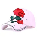Close-up of pink cotton baseball cap with red rose embroidery and silver studs - One Size / Pink