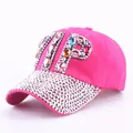 Detailed view of VIP rhinestone lettering and sparkling crystals on rose red baseball cap - Colorful Rhinestone Rose Red