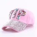 Close-up of pink baseball cap featuring rhinestone VIP letters and crystal brim details - Colorful Rhinestone Pink