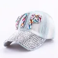 Detailed view of hand-set rhinestones and VIP crystal lettering on blue denim cap - Colorful Rhinestone Denim 1