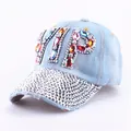 Detail of light blue denim baseball cap featuring VIP colorful gems and rhinestone brim - Colorful Rhinestone Denim 2