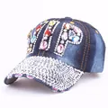 Detailed view of VIP logo made of colorful rhinestones on blue denim baseball cap - Colorful Rhinestone Denim 5