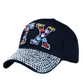 Black canvas baseball cap featuring colorful TX rhinestone letter and crystal brim detail - One Size / Black