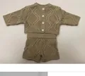 Macro shot of khaki knit two-piece baby doll outfit with textured diamond patterns - Knitted Cardigan And Shorts Outfit (Fits 50-55cm Dolls) / Khaki