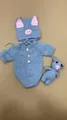 Detailed view of hand-knitted light blue baby doll outfit with cute pig hat and toy - 50-55cm