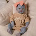 Macro detail of 19 inch blue skin reborn doll with yellow eyes and rainbow embroidery - Full Silicone Body (49cm) / Fantasy Blue