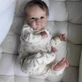 Close-up of realistic newborn baby doll in squirrel print onesie on white quilted pad - Skin Tone (Off-white Romper) / 48cm Cloth Body Style