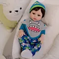 Realistic 18-inch reborn baby doll in a shark-themed outfit resting in a white nest - 48cm Full Silicone Body (Shark Set)