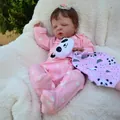 Lifelike 19-inch reborn baby doll Louisa in pink heart onesie sleeping on white fur rug - Cloth Body Style / Pink (As Shown)