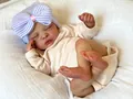 Reborn baby doll sleeping in pink romper with blue striped bow hat 18 inch size - Cloth Body Style / Pink And Beige