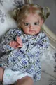 24-inch realistic blonde toddler doll wearing blue floral print outfit and pigtails - Blue Floral Style / Cloth Body Style