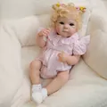 Lifelike 18-inch Reborn baby doll with blonde hair and pink gingham romper on sofa - Large Full Silicone Model / Pink Plaid Style