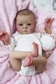 Lifelike reborn doll in white cotton romper lying on pink plush blanket with bunny toy - 16 Inch Realistic Doll (RBG29)