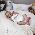 Realistic 19-inch reborn baby girl doll in white romper sleeping on soft blanket - 19 Inch Full Vinyl