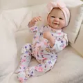 Realistic 19-inch reborn baby doll in floral bunny print onesie and pink bow headband - 48cm / Pink Print Romper Style