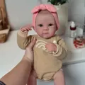 Realistic 19-inch reborn baby doll in pink headband and khaki rainbow knitted romper - Rainbow Khaki Romper (Exquisite Painted)