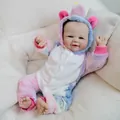 Realistic 19-inch Vivienne baby doll wearing a colorful plush tie-dye unicorn onesie - Unicorn Onesie Style / Full Vinyl Model / As Shown
